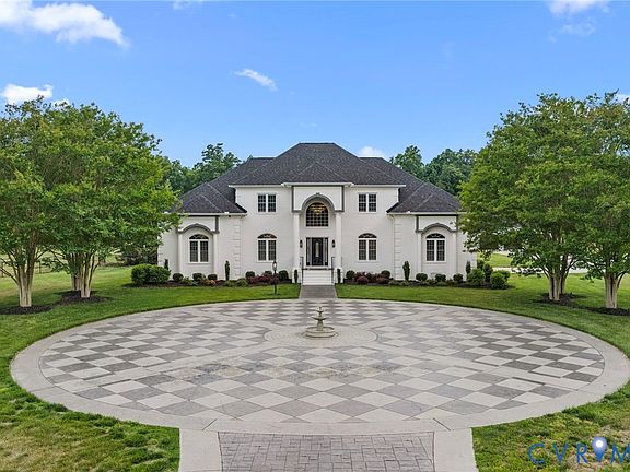 A second long view across the front of the property and into the wooded acreage beyond